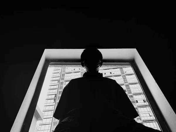 black and white photo of a young man in a suit and a veil in the room