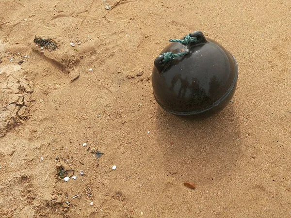 a closeup shot of a beach ball on a sandy shore