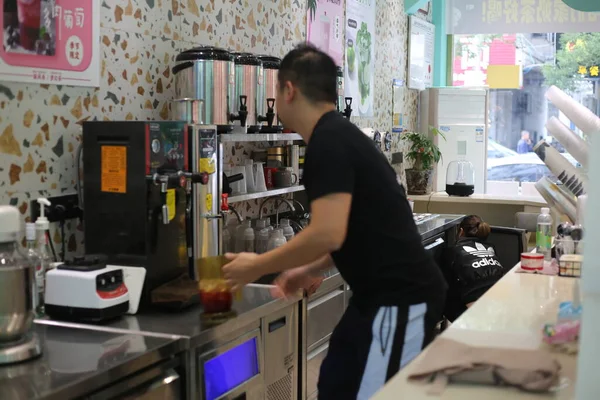 female hand with a sewing machine in the store