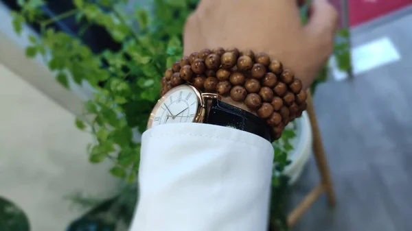 close up of a woman's hand holding a purse with a coin