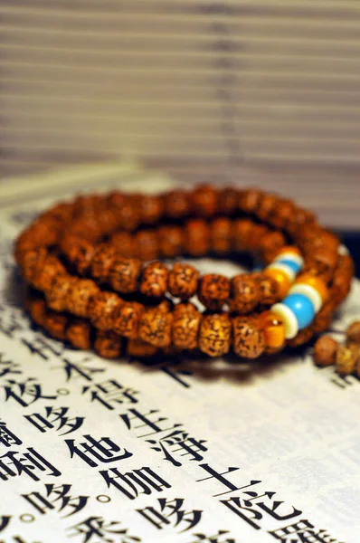 traditional indian rosary beads on a wooden background