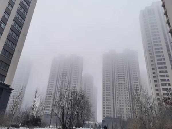 modern city buildings in the fog