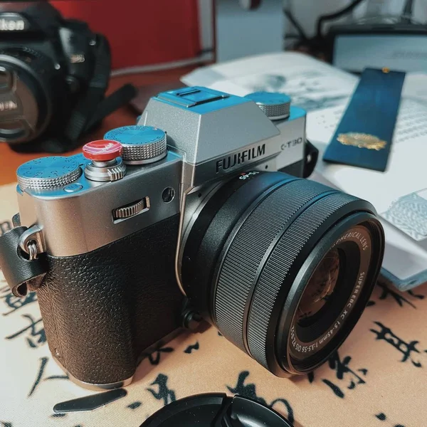 old camera with a vintage film and a photo of a retro slr cameras on a wooden background.