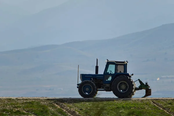 Traktor som utför jordbruksarbete på fältet — Stockfoto