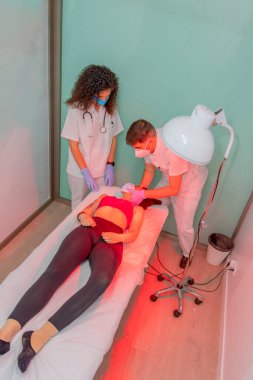 Doctor working on the back of a young woman