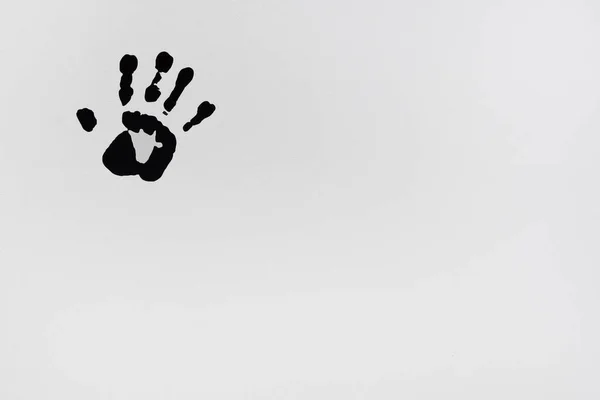 Black paint handprint, on white background. Palm of the hand. — Stock fotografie