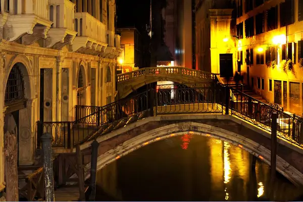 Canals of Venice illuminated at night in Italy. — Photo