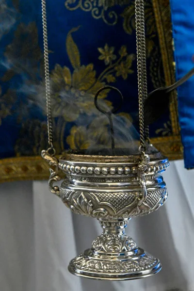 Silver censer lit and smoke rising during a procession — ストック写真