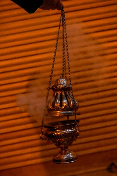 Golden censer lit and smoke rising during a procession — Stock Photo, Image