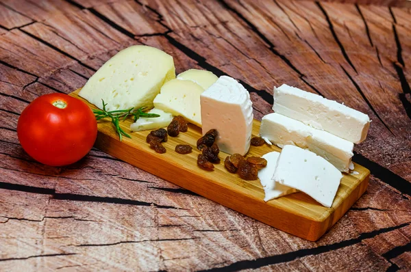 Table Fresh Assorted Goat Cheeses Cut Wedges Wooden Board — Stock fotografie