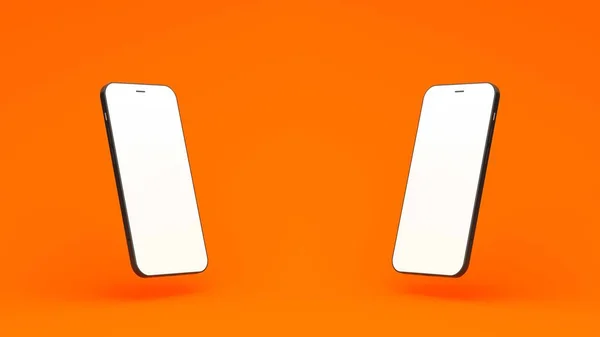 オレンジの背景に2台のスマートフォンを並べて — ストック写真