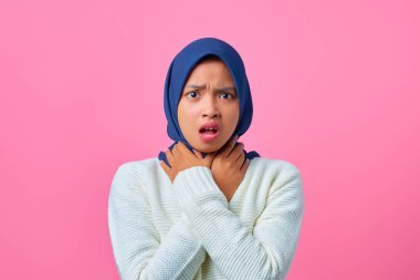 Genç Asyalı kadın portresi, pembe arka planda boğularak can çekişiyor.