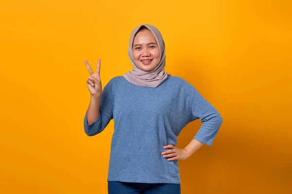 Portrait Cheerful Asian Woman Standing Doing Victory Sign Yellow Background — Stok Foto