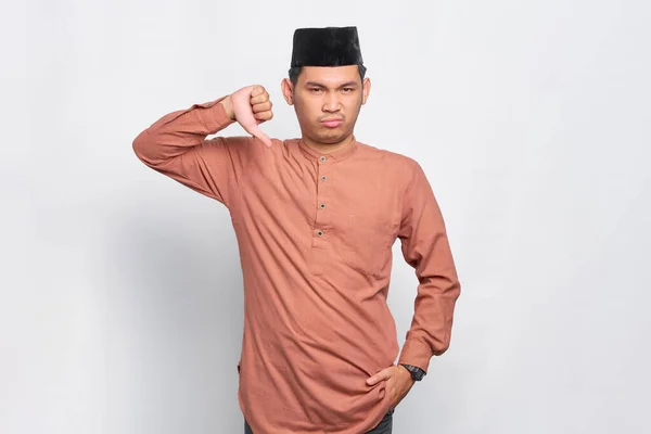 Annoyed Young Asian Muslim Man Showing Thumbs Isolated White Background — Stock Photo, Image