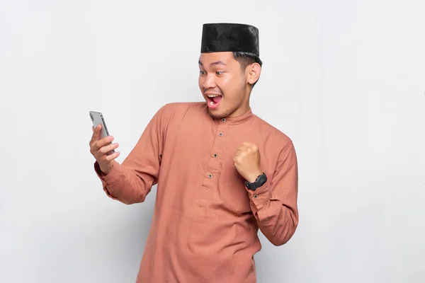 Excited Young Asian Muslim Man Using Mobile Phone Celebrating Success — Stock Photo, Image