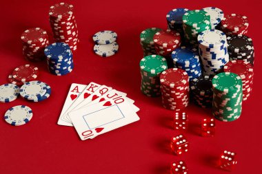 Casino gambling poker equipment and entertainment concept - close up of playing cards and chips at red background. Royal flush heart. clipart