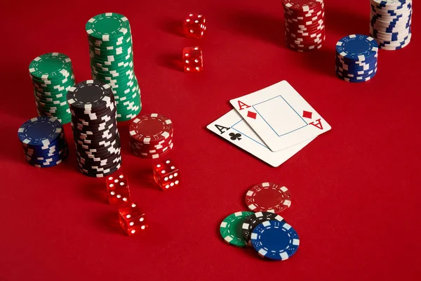 Poker chips and aces on red background. Group of different poker chips. Casino background. — Stock Photo, Image