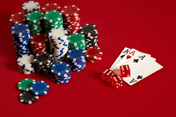Casino gambling poker equipment and entertainment concept - close up of playing cards and chips at red background. Three of a Kind — Stock Photo, Image