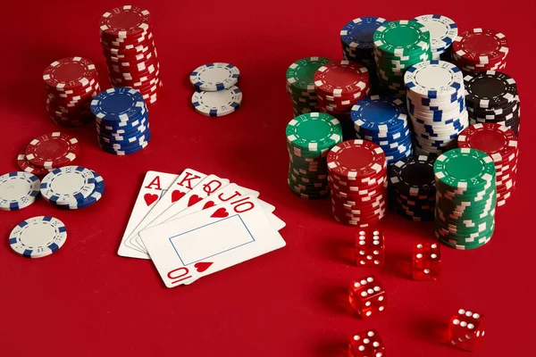 Casino gambling poker equipment and entertainment concept - close up of playing cards and chips at red background. Royal flush heart. — Stock Photo, Image
