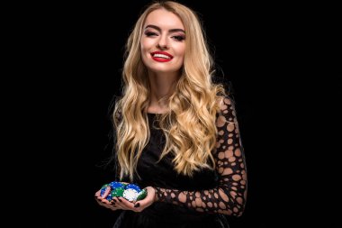 Siyah elbiseli, casino oyuncu fiş bir avuç siyah arka plan üzerine zarif sarışın