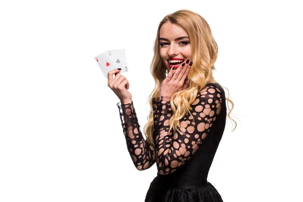 Όμορφη νεαρή γυναίκα κρατώντας δύο άσος των καρτών στο χέρι της απομονωμένη σε μαύρο φόντο — Φωτογραφία Αρχείου