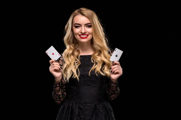 Beautiful young woman holding two ace of cards in her hand isolated on black background  Stock Photo, Image