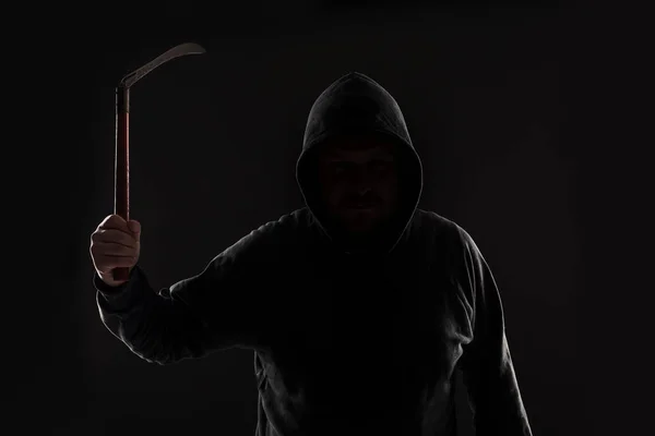 Criminal in dark clothes and balaclava with scythe — Stock Photo, Image