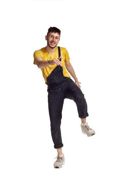 Full-length portrait of a funny guy dancing in studio isolated on white background. — Stock Photo, Image