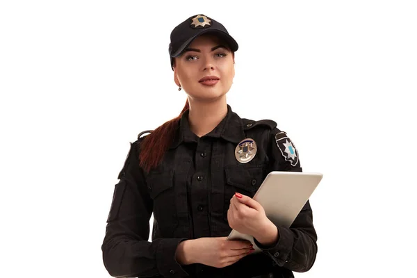 Close-up portrait of a female police officer is posing for the camera isolated on white background. — Stock Photo, Image