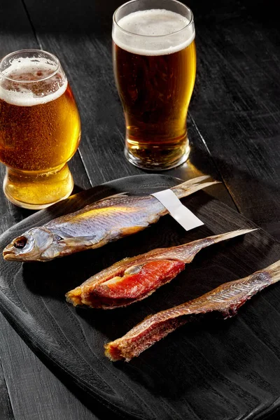 Whole salted air-dried roach fish and two peeled fish with caviar served with beer