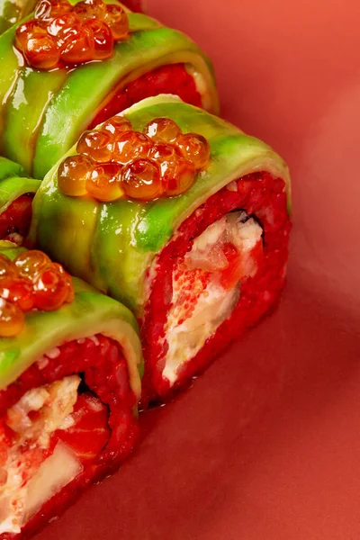 Kırmızı pilav, krem peynir, somon, elma, tobiko, avokado, kırmızı arka planda havyar...