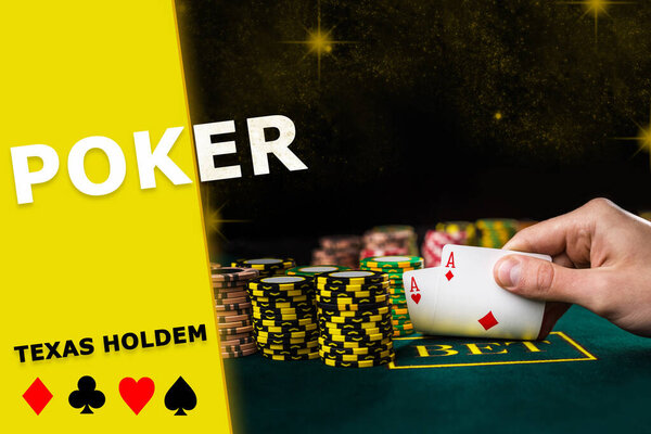 Hand of man raising aces from green table. Stacks of chips standing nearby, black background. Poker, texas holdem, card suits on yellow insert. Casino