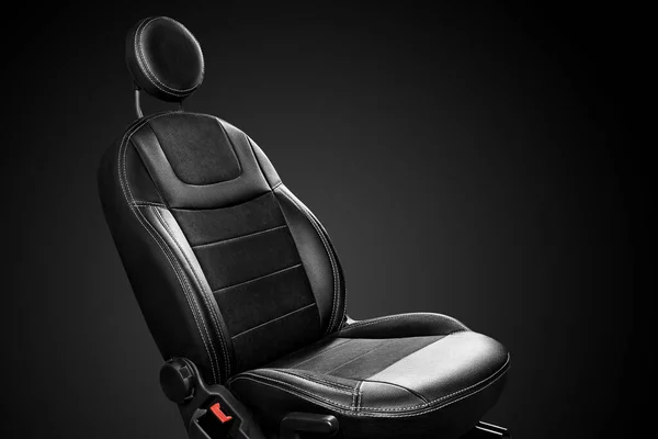 Ergonomic driver car seat with round headrest isolated on black background — 图库照片