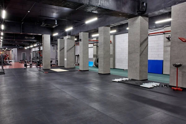 Espaçoso, bem iluminado, ginásio interior com máquinas de musculação para treinamento físico e outros equipamentos modernos especiais. Desporto, fitness — Fotografia de Stock