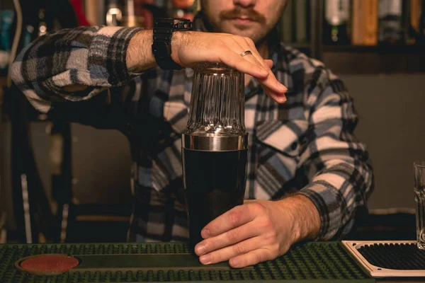 Профессиональный бармен делает коктейль для гостей в шейкере — стоковое фото