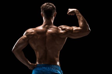 Güçlü Atletik Adam Fitness Modeli sırt kasları, siyah arka plan üzerinde trisepsler. Siyah arkaplanda stüdyo çekimi.
