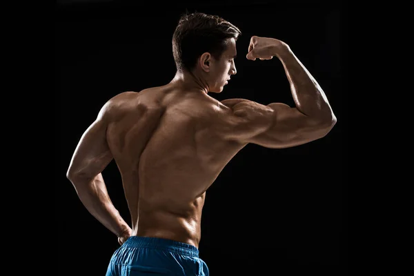 Stark Athletic Man Fitness Modell Poserar Ryggmusklerna Triceps Över Svart — Stockfoto
