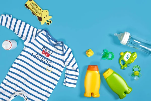 Baby Care Bath Set Nipple Toy Clothes Shampoo Blue Background — Stock Fotó