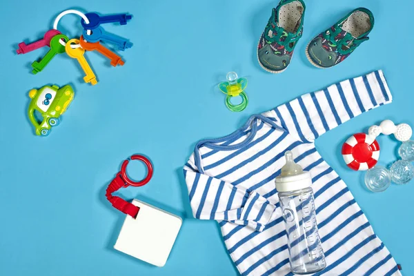 Bebek Kıyafetleri Tuvalet Eşyaları Oyuncaklar Mavi Arka Planda Sağlık Malzemeleri — Stok fotoğraf