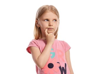 Close-up portrait of a lovely blonde child with a long hair, in a pink t-shirt, looking thoughtful while posing isolated on white background with copy space. Concept of a joyful childhood.