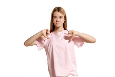 Studio portrait of a charming blonde adolescent in a pink t-shirt isolated on white background in various poses. She expresses different emotions posing right in front of the camera, smiling and