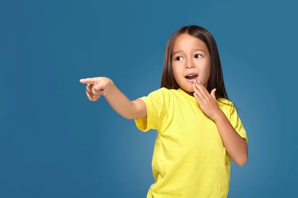 Cute Girl Shows Her Finger Blue Background — ストック写真