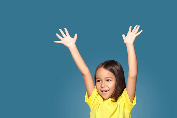 Little Girl Raising Her Hands Blue Background — ストック写真