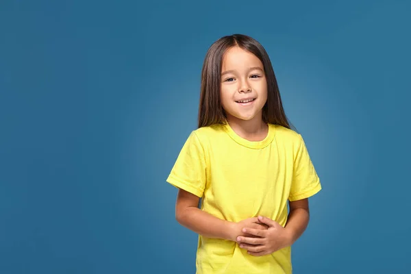 Little Girl Yellow Shirt Smiling Blue Background — Stok fotoğraf