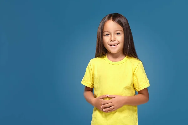 Little Girl Yellow Shirt Smiling Blue Background — Stock Fotó