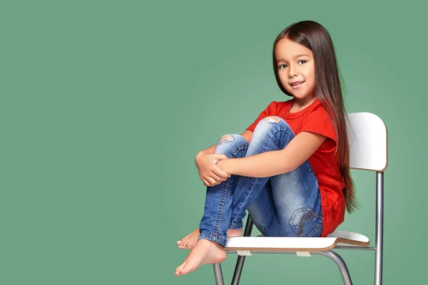 Little Girl Wearing Red Short Posing Chair Green Background — ストック写真