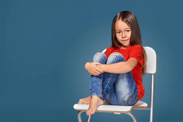 Little Girl Wearing Red Short Posing Chair Blue Background — Stock Fotó