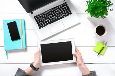 Hand use white tablet on desk table top view. Copy space flat lay on white background