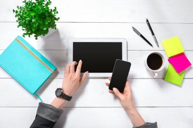 Hand use tablet on desk table top view. Copy space flat lay on white background