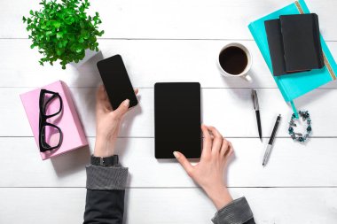 Hand use tablet on desk table top view. Copy space flat lay on white background